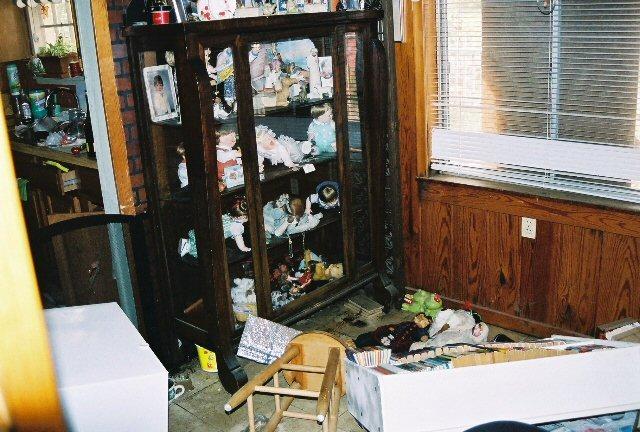 home_30Aug_16.jpg - Kathy's aunt's antique china cabinet and Kathy's doll collection. Pretty much a loss.