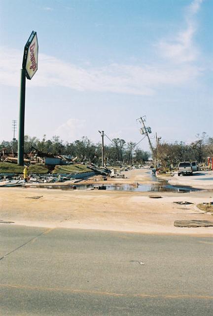 moms_house01.jpg - View looking up Brady Drive from Hwy 90. There was the erie sound and smell of natural gas all over due to all gas not being turned off yet.