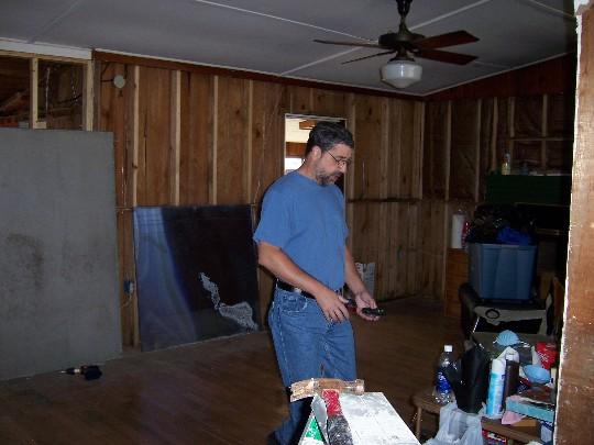 house12.JPG - Randy working in the living room