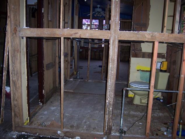 house18.JPG - Looking into a bathroom from the kitchen, back bedroom is in the background