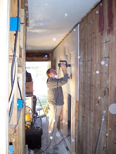 house39.JPG - Kathy cutting out the doorway to the back bedroom.