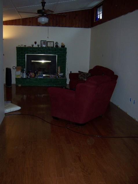 house84.jpg - Finally, the beginings of a living room again. New hardwood floors in and walls painted.